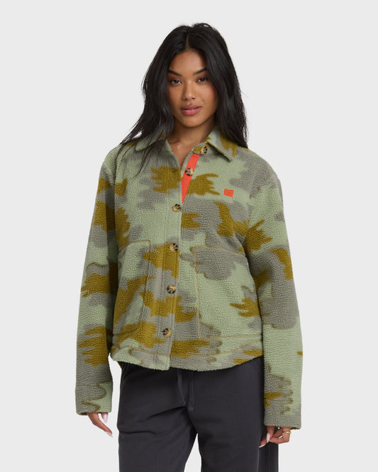 Camouflage sherpa shacket with olive and yellow pattern, button front, and red interior visible at collar.