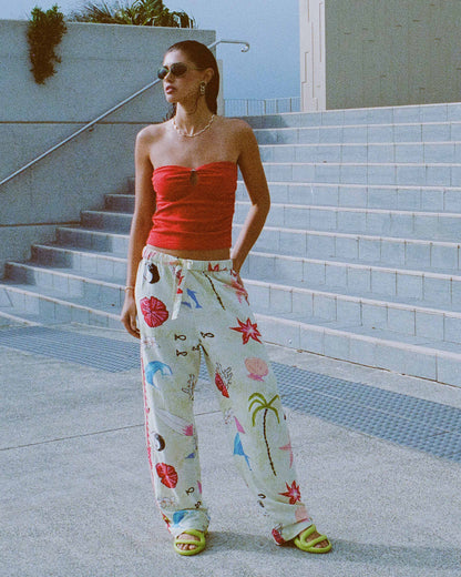 Cream woven pants with colorful floral and botanical print, elastic waistband, relaxed fit.