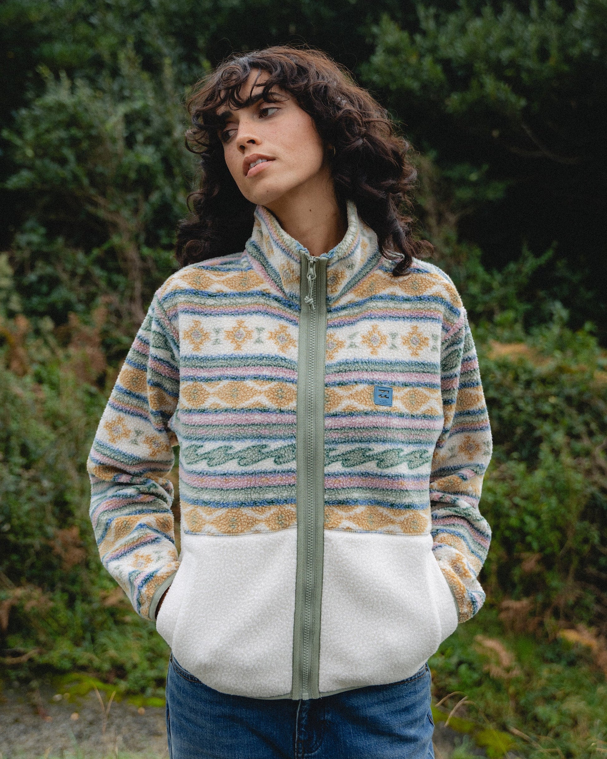 White and multicolored striped sherpa fleece jacket with mock neck and full-length zip.