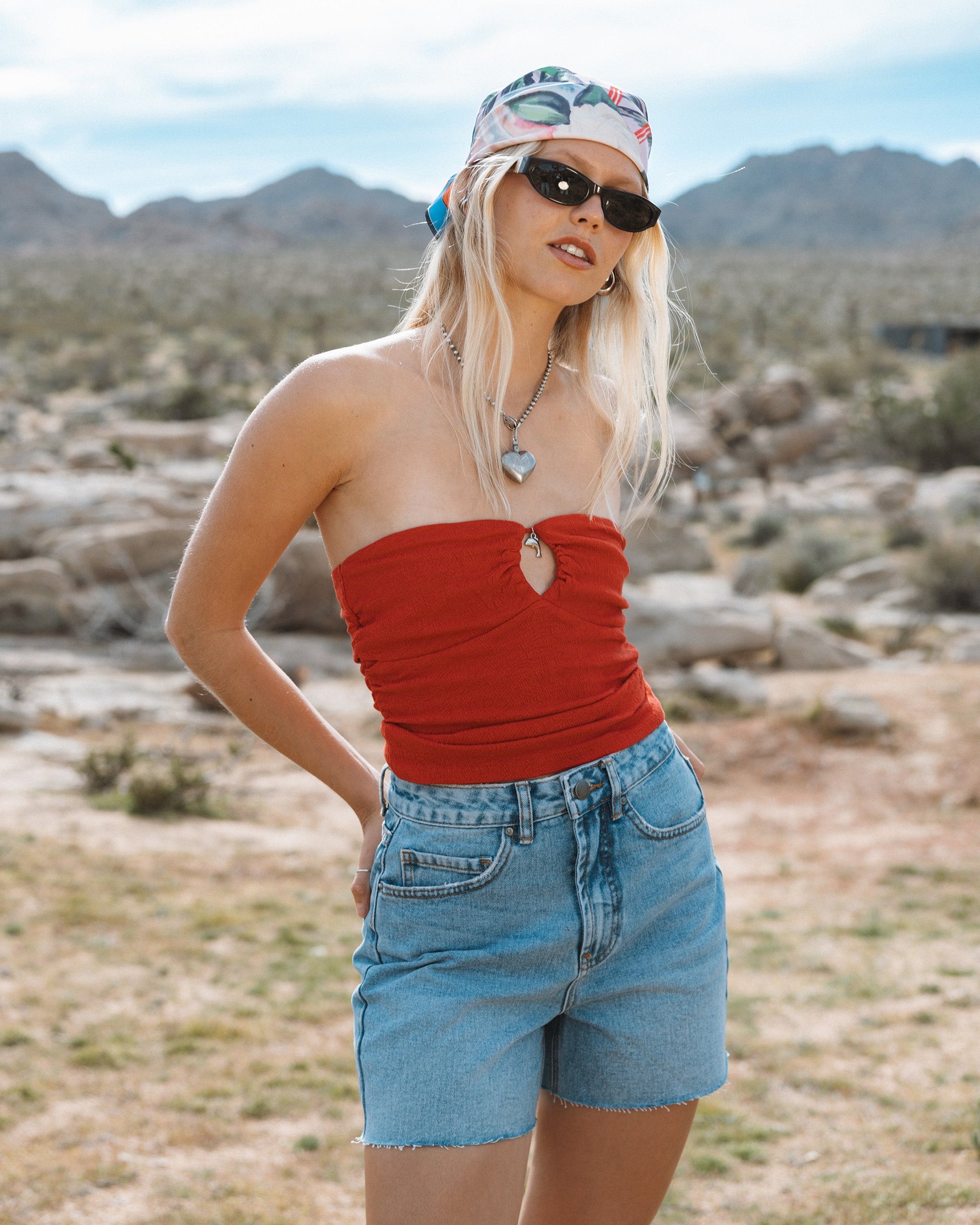 Faded indigo denim cut-off shorts with frayed edges and a high waistline.