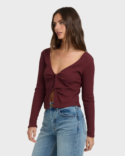 Burgundy ribbed long-sleeve knit top with twisted front detail and V-neckline.