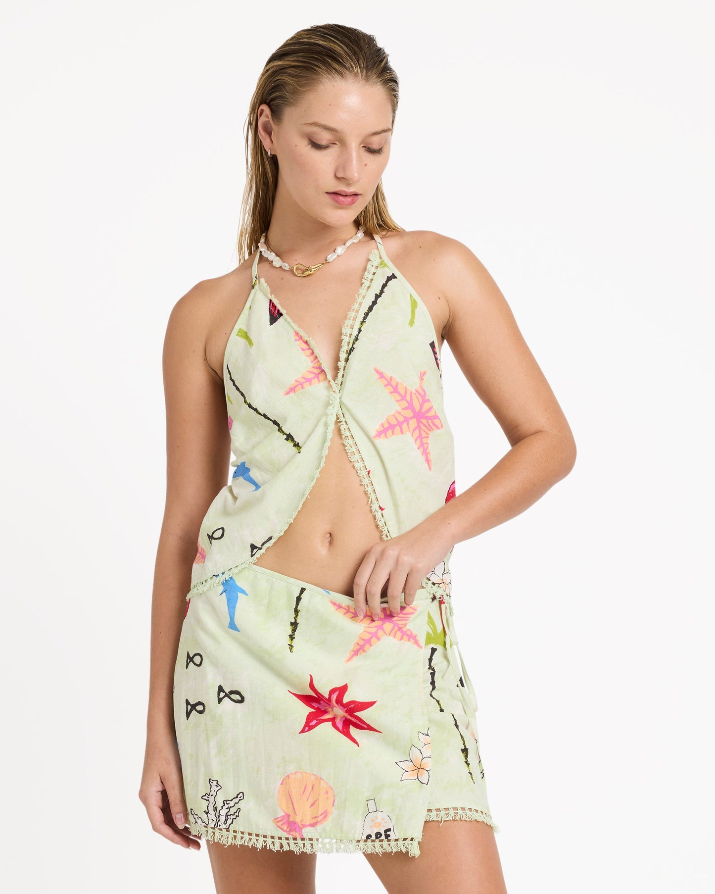 Lime green woven halter tank with colorful embroidered floral and geometric patterns throughout.