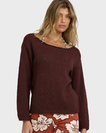 Teak ribbed sweater with wide neckline worn with patterned skirt.
