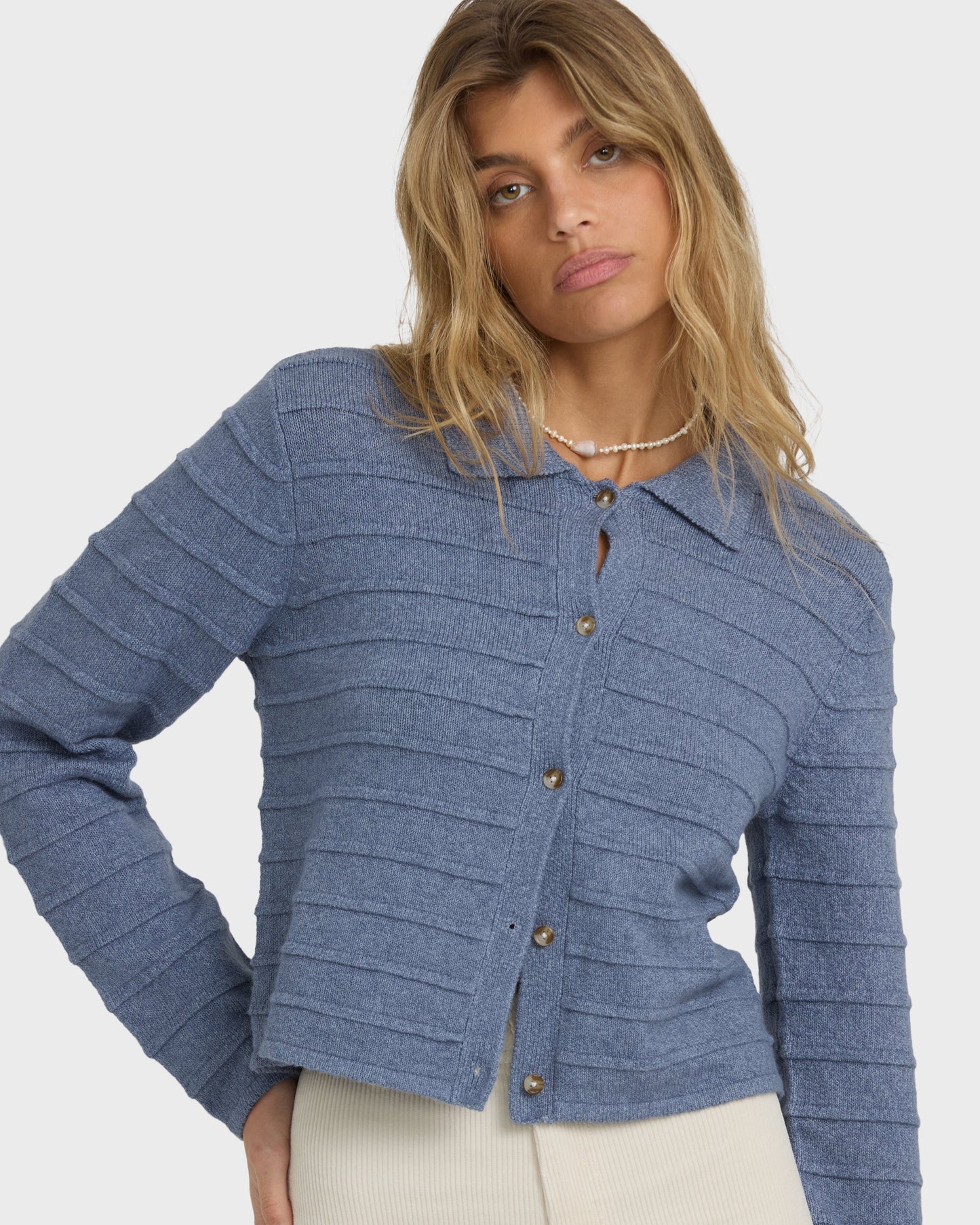 Stone blue knit cardigan with horizontal ribbed texture and button front closure.