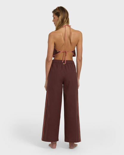 Teak elastic waist pants with wide legs and side stripe detail, shown from back view on model.