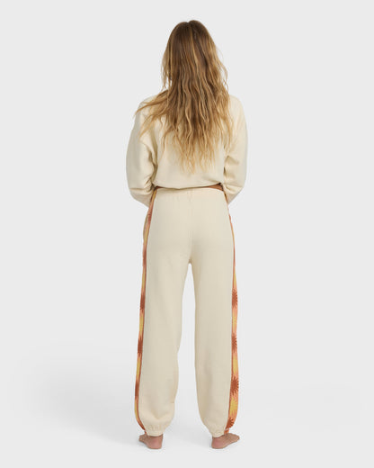 Cream joggers with floral patterned side stripe, shown from back on model wearing matching cream sweatshirt.