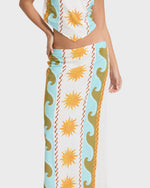 Midi skirt with sun and wave print in cream, light blue, gold, and red stripes.
