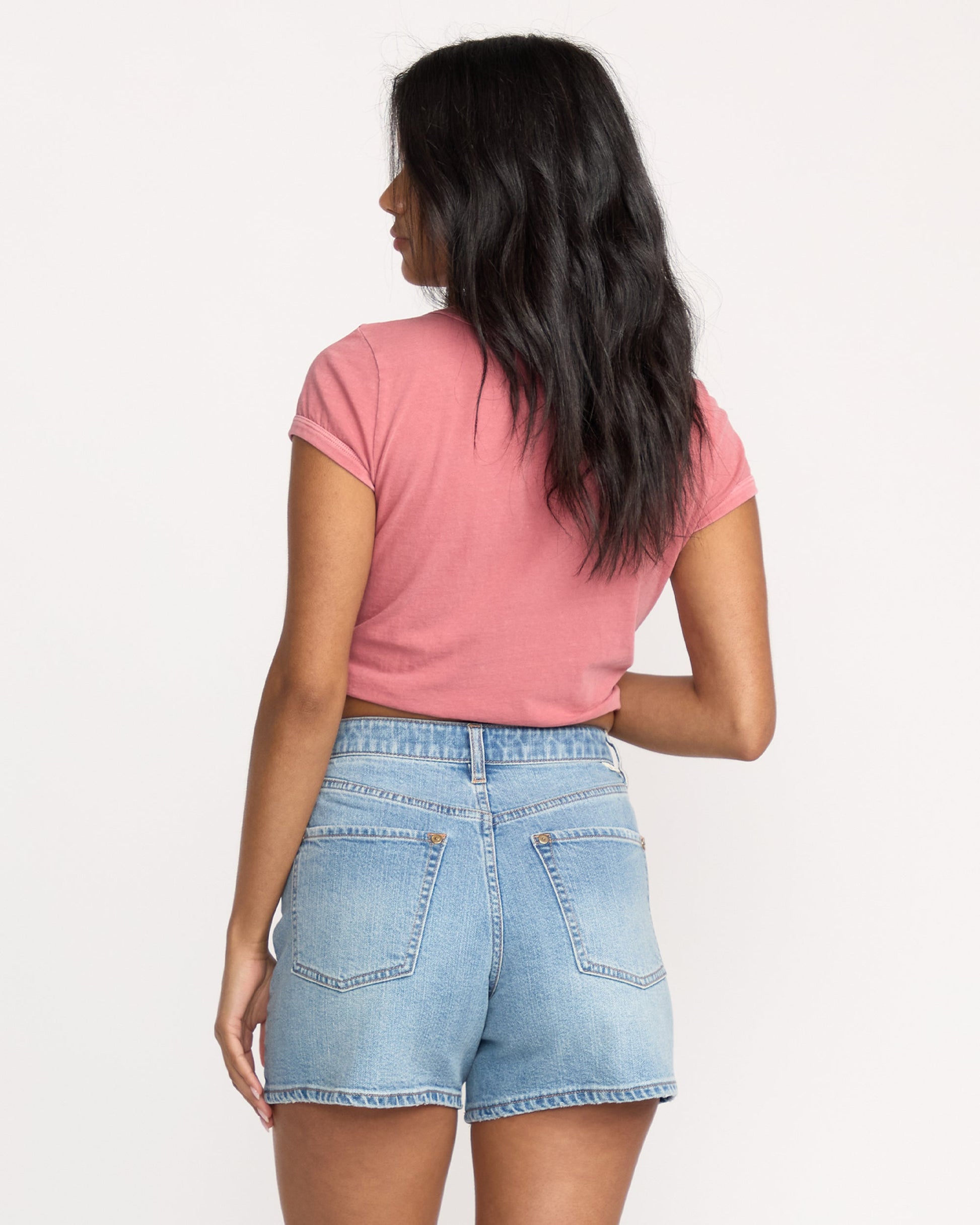 Light wash denim shorts with five-pocket styling and a mid-rise waistband, shown from the back.