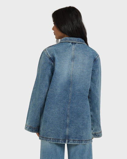 Medium-wash denim chore coat with collar and center seam, shown from back on model.