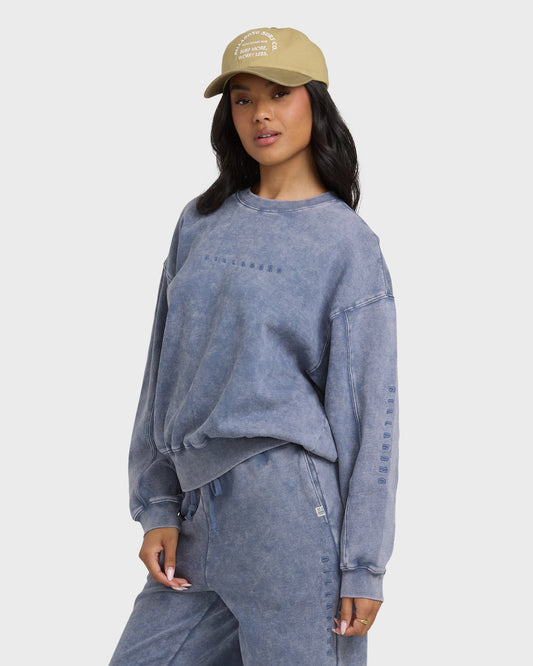 Stone blue saltwashed crewneck sweatshirt with embroidered text on chest and sleeve.