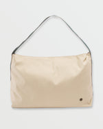 Coyote-colored shoulder bag with braided dark strap and small circular logo detail on front.