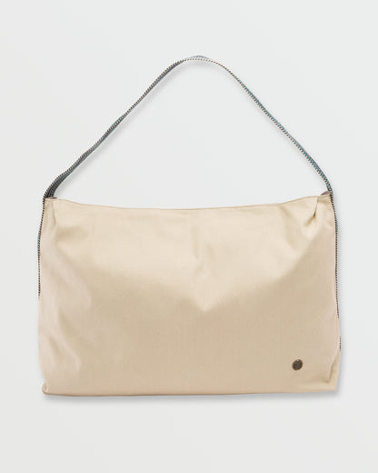 Coyote-colored shoulder bag with braided dark strap and small circular logo detail on front.