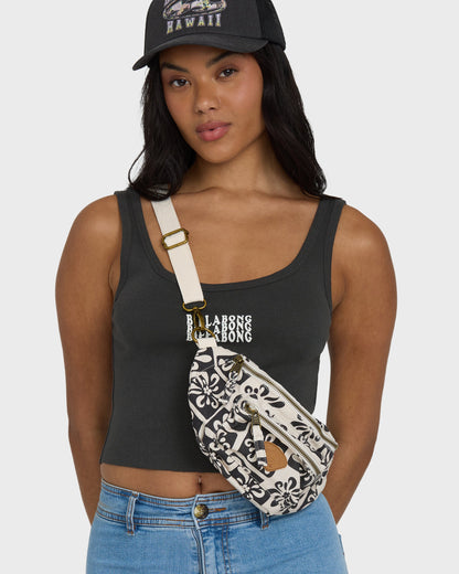 Black and white patterned waistbag with cream shoulder strap and gold hardware, worn across torso.