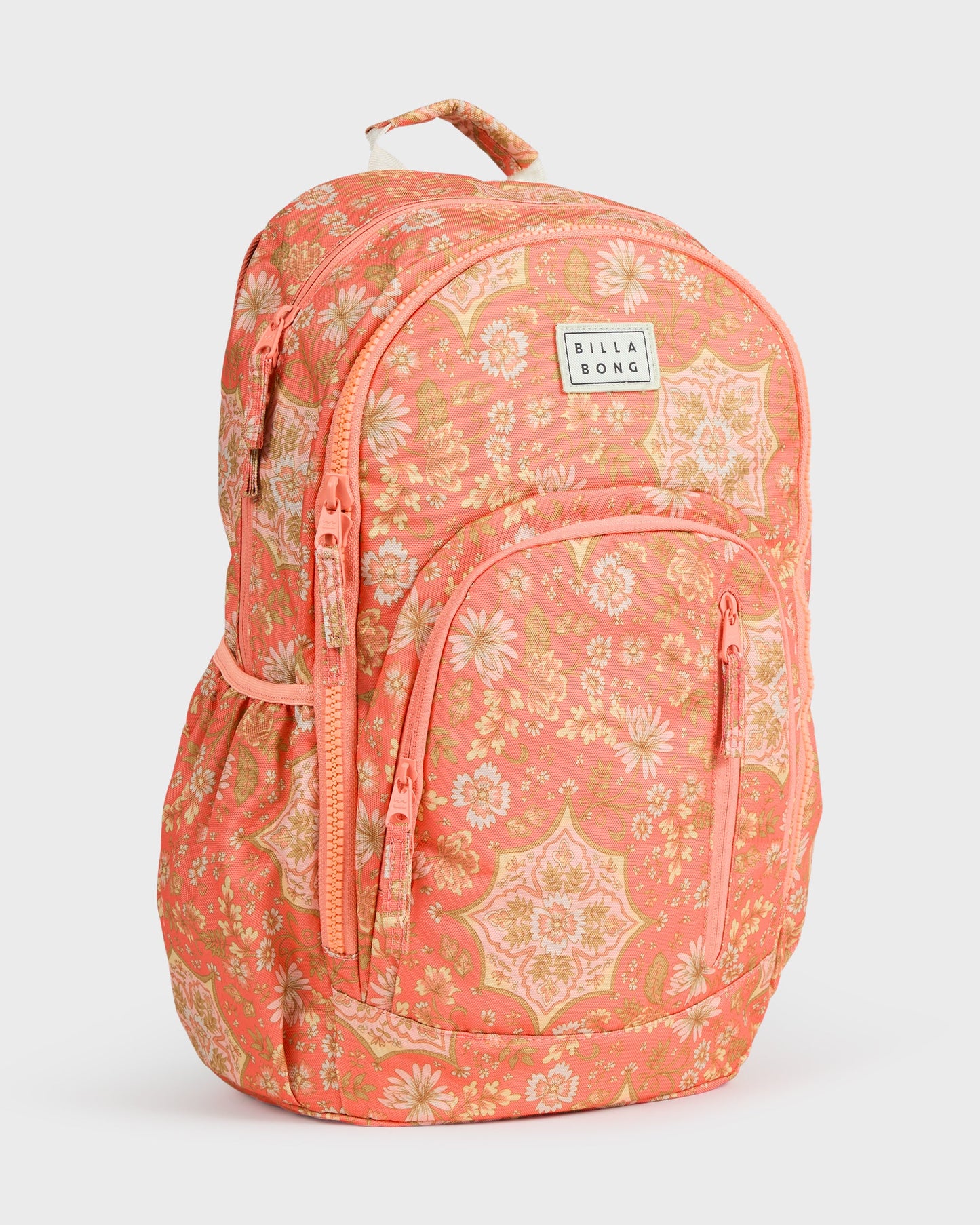 Coral backpack with floral and geometric pattern, front zippered pockets, padded straps, and Billabong branded patch.