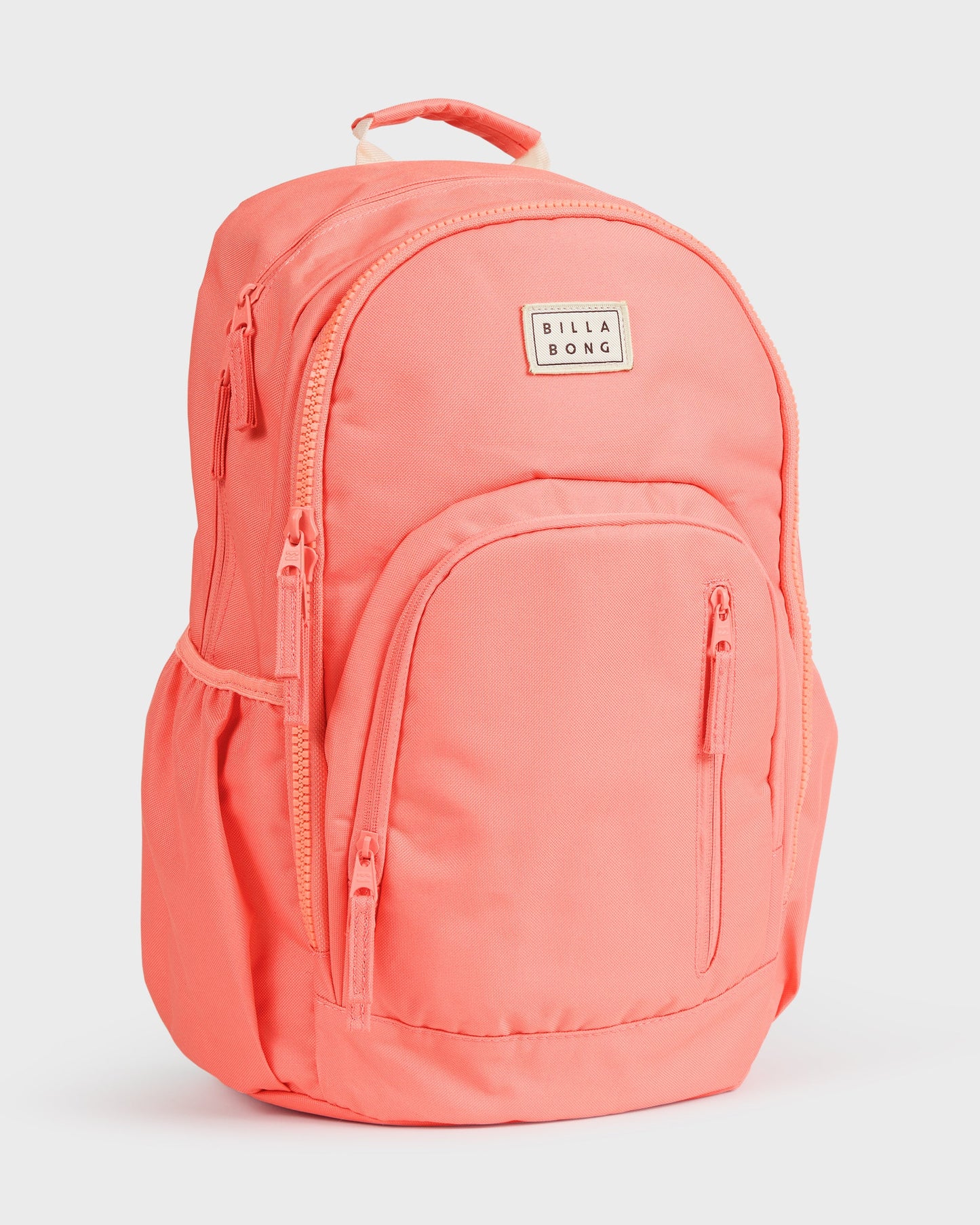 Papaya-colored backpack with multiple zippered compartments, padded straps, and Billabong logo patch.