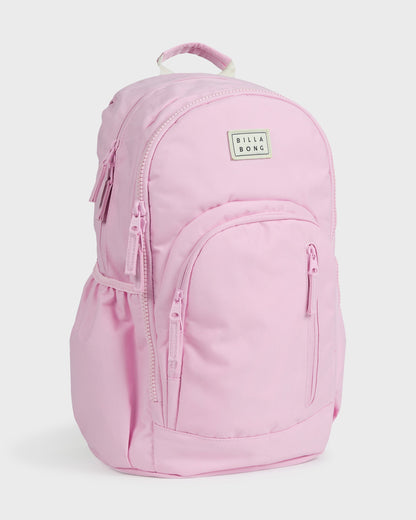 Light pink backpack with padded straps, front pocket, and Billabong logo patch on main compartment.