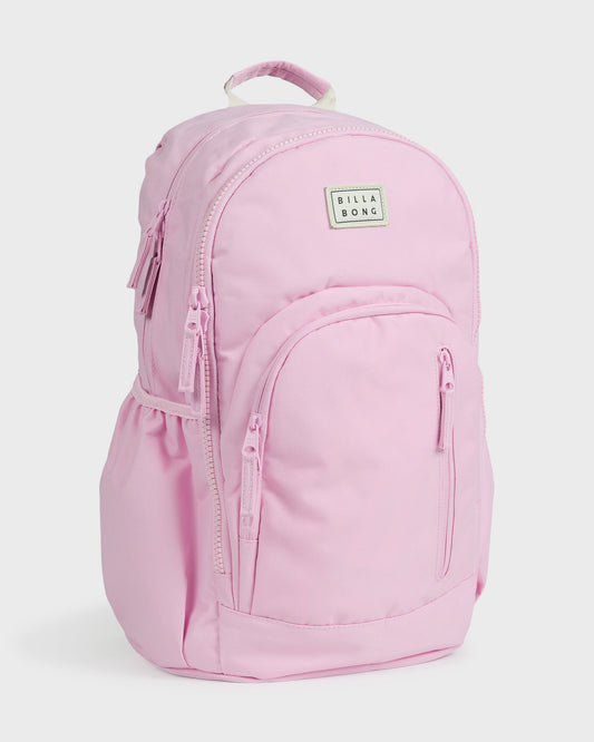 Light pink backpack with padded straps, front pocket, and Billabong logo patch on main compartment.