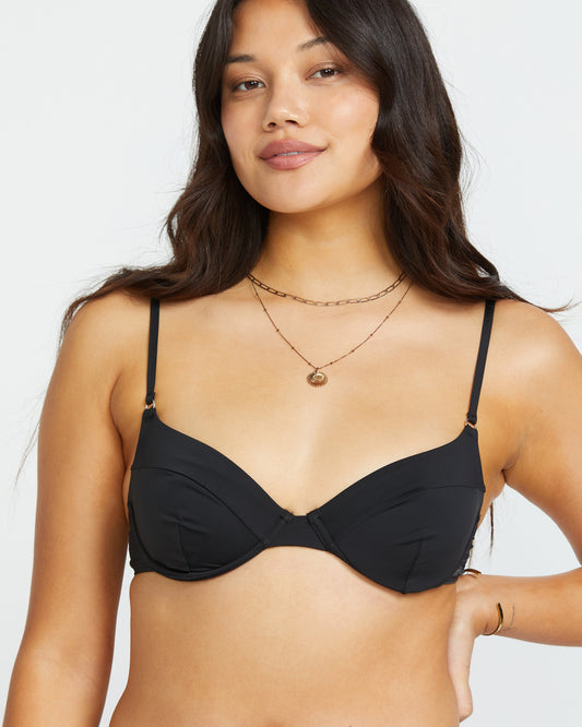 Black underwire bikini top with thin shoulder straps and sweetheart neckline on model.