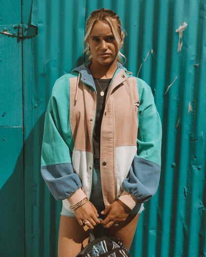 Aqua haze jacket with color-blocked panels in teal, cream, and blue, featuring a collared neckline and button front.
