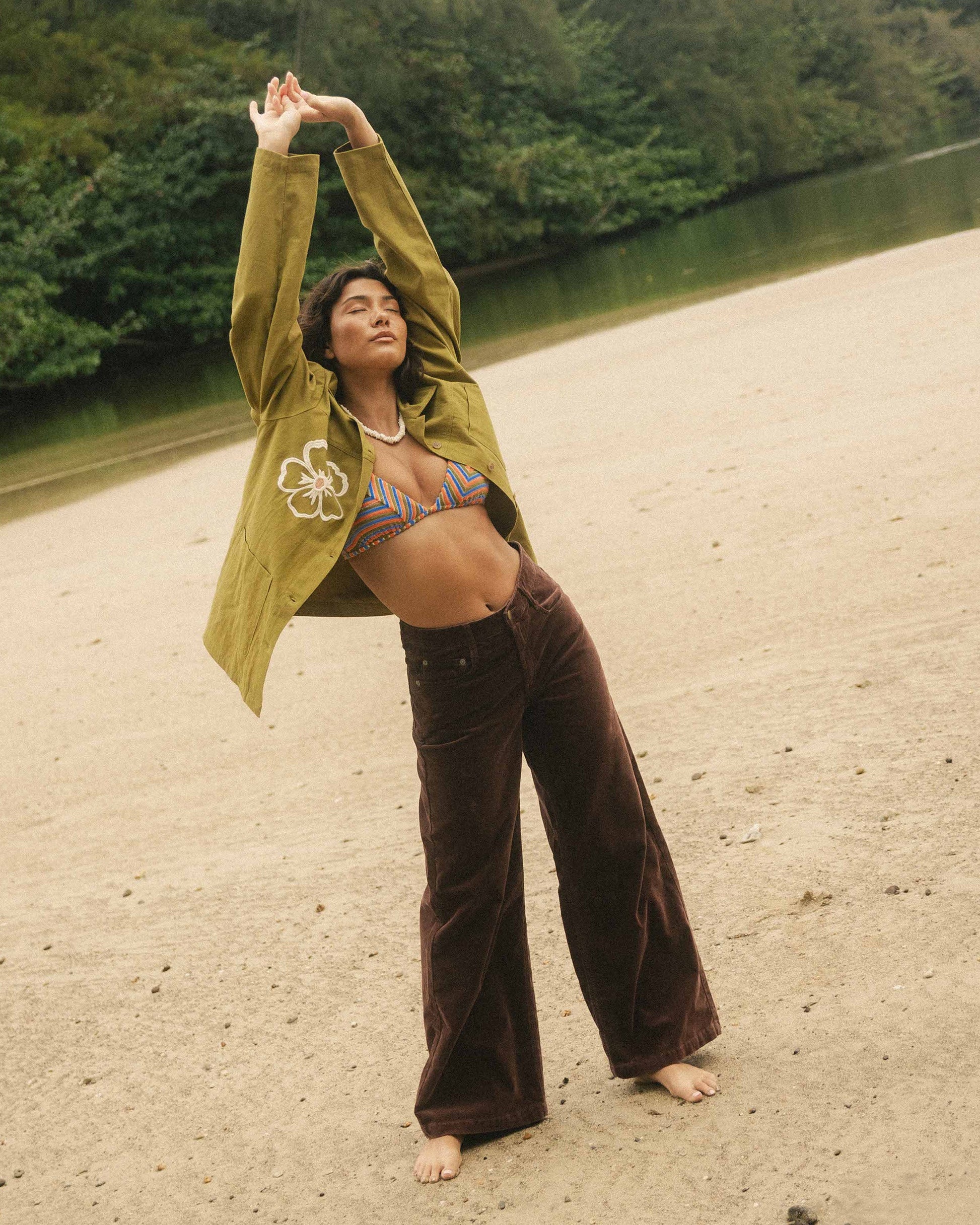 Brown corduroy pants with wide legs worn at ankle, shown on model outdoors.