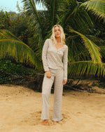 Martini olive knit pants with textured waffle weave fabric, shown with matching cardigan on model.