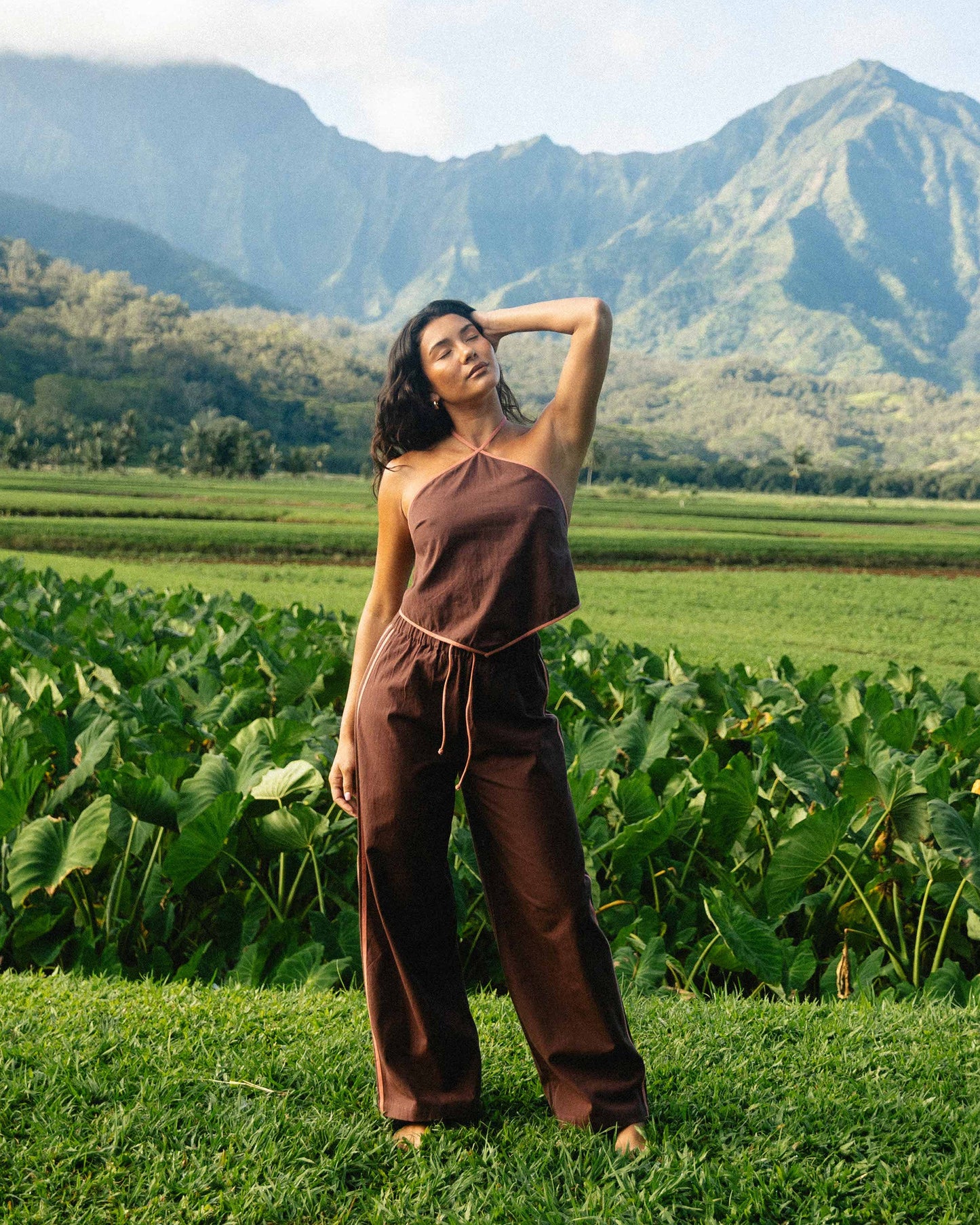 Teak-colored elastic waist pants with drawstring, worn with matching sleeveless top in outdoor setting.