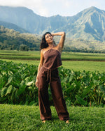 Teak-colored elastic waist pants with drawstring, worn with matching sleeveless top in outdoor setting.