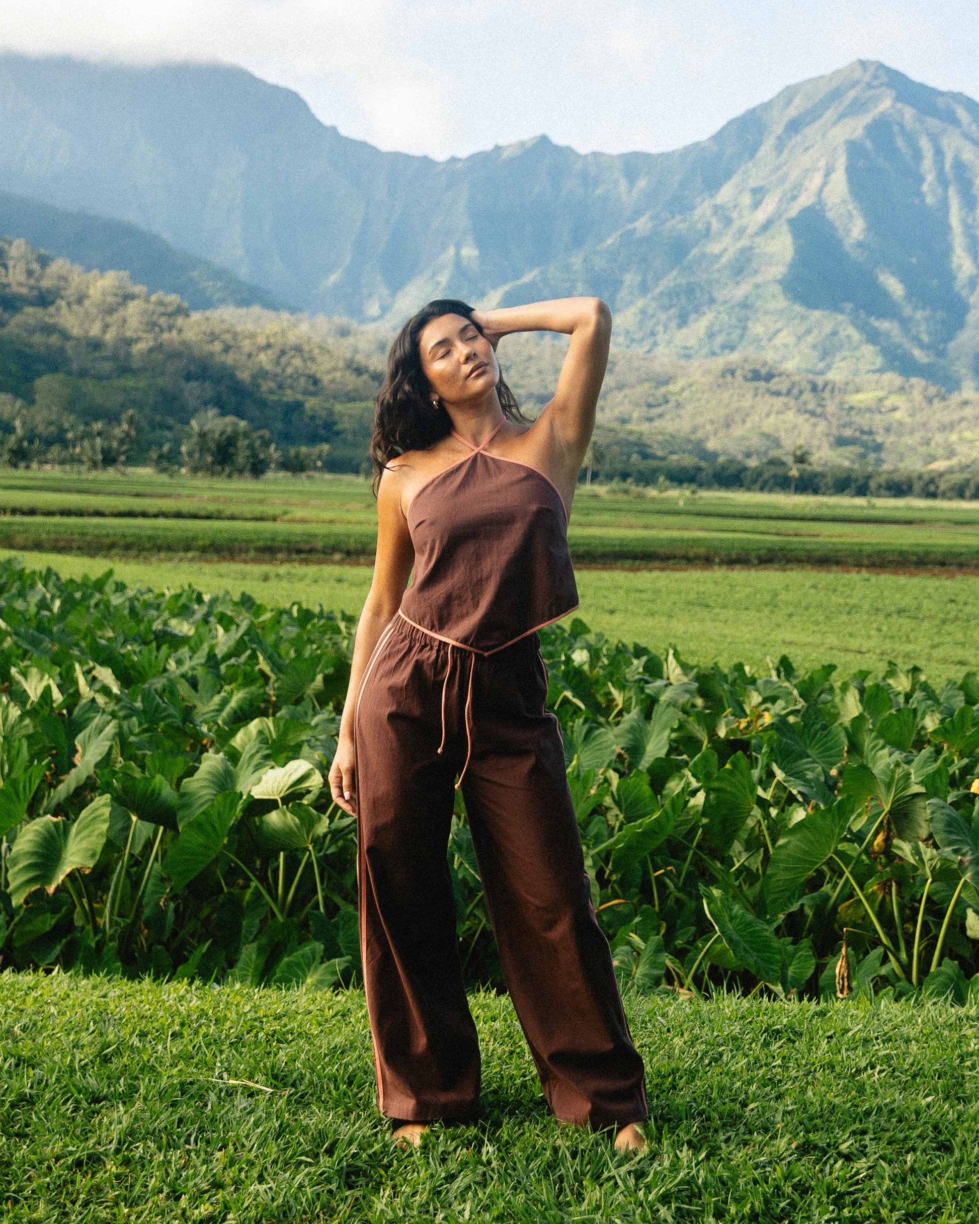 Teak-colored elastic waist pants with drawstring, worn with matching sleeveless top in outdoor setting.