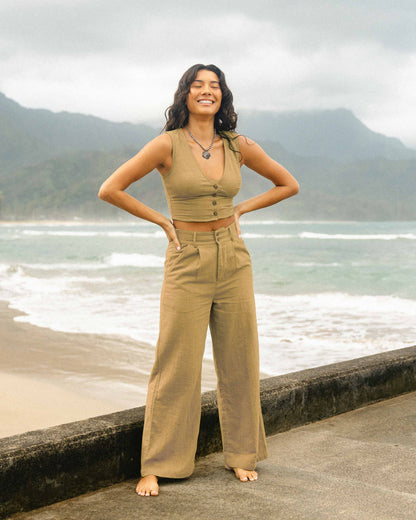 Tan sleeveless cropped vest with button front and matching high-waisted wide-leg pants.