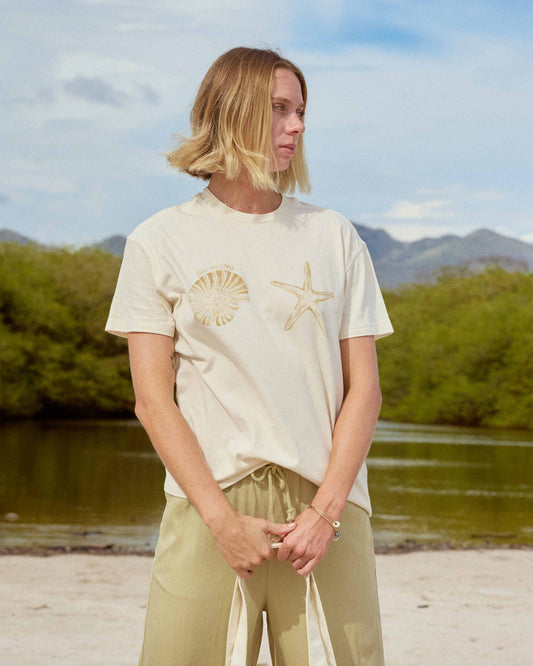 White short sleeve knit t-shirt with shell and starfish graphic on chest.