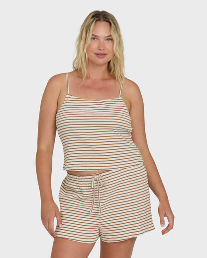 Brown and white striped sleeveless tank top with thin shoulder straps on a model.