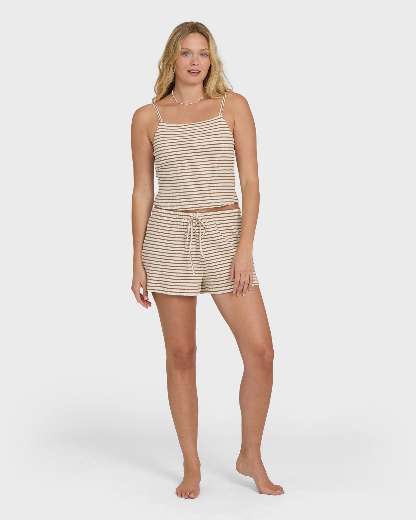 Brown and cream striped tank top with matching drawstring shorts on model.