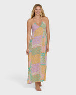 Halter maxi dress in patchwork print with violet, yellow, and teal colored blocks.