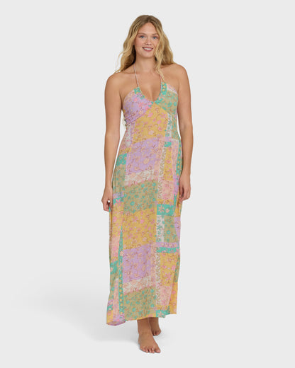 Halter maxi dress in patchwork print with violet, yellow, and teal colored blocks.