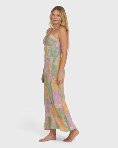 Violet maxi dress with multicolored floral patchwork pattern and halter neckline on model.