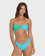 Teal and bright blue color-block bandeau bikini top with twisted center detail on model.