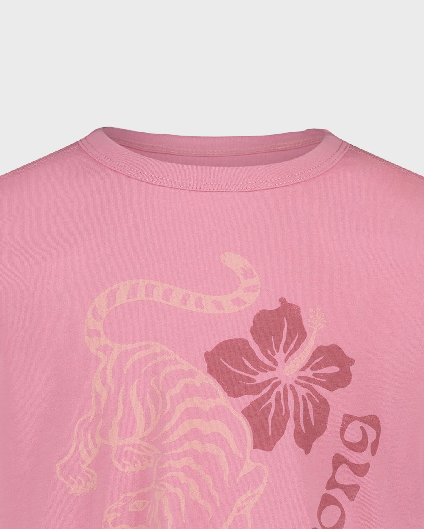 Pink t-shirt with a tiger and floral design on a light gray background