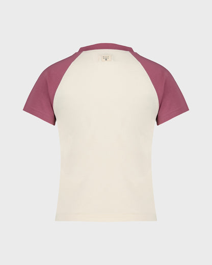 Two-tone t-shirt with maroon sleeves and cream body on a light gray background