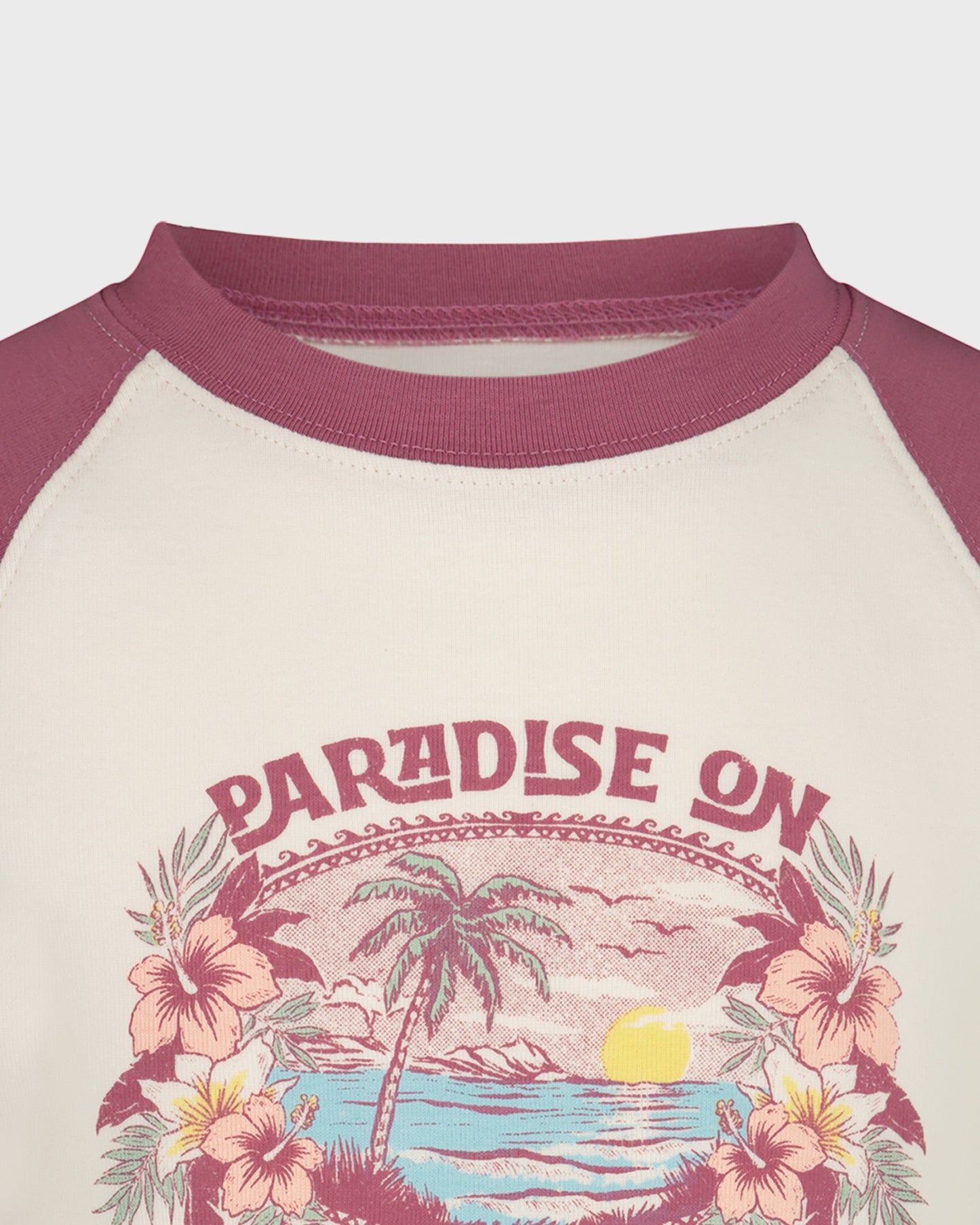 Children's shirt with 'Paradise On' design featuring a palm tree and flowers on a beige background.