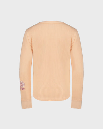 Beige ribbed sweater with a small logo on the sleeve against a light gray background