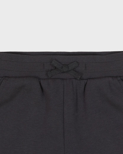 Dark gray sweatpants with a drawstring on a light gray background