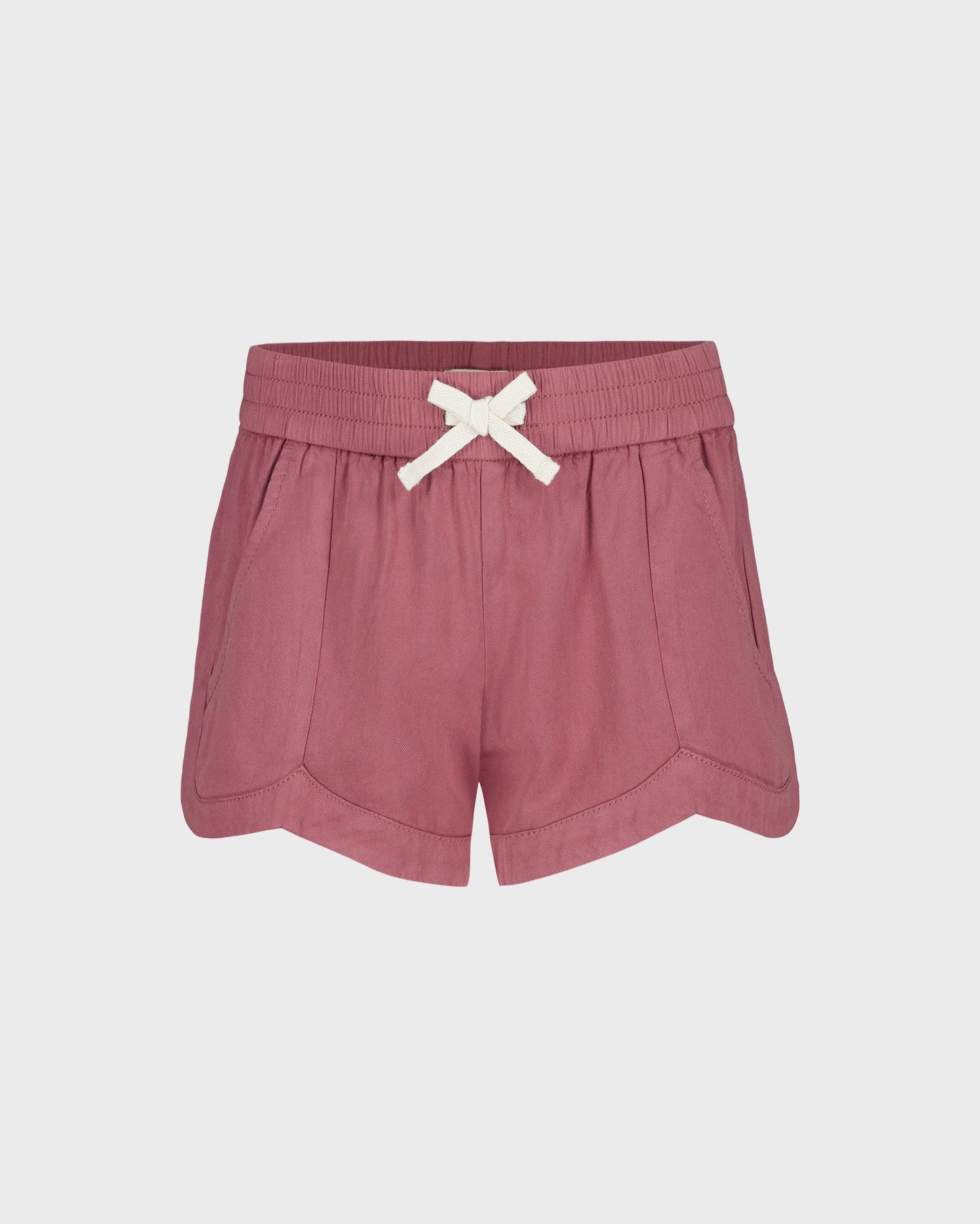 Pink shorts with a white bow on a light gray background