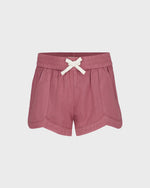 Pink shorts with a white bow on a light gray background