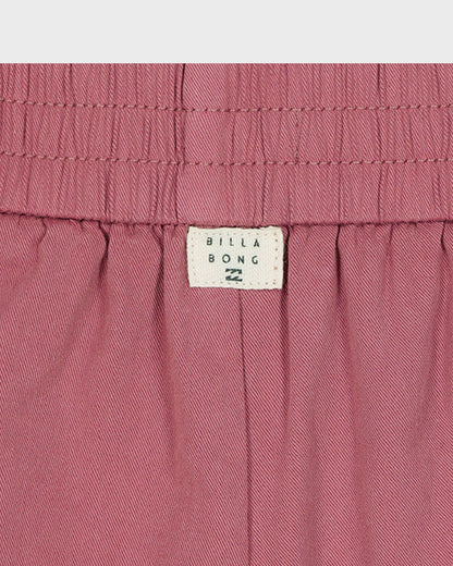 Close-up of pink shorts with Billabong label