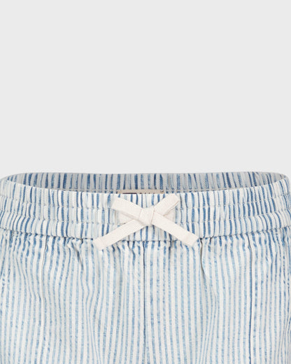 Blue and white striped shorts with a white bow on a light gray background