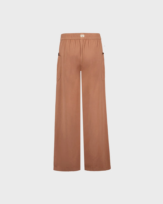 Brown wide-leg pants on a light beige background