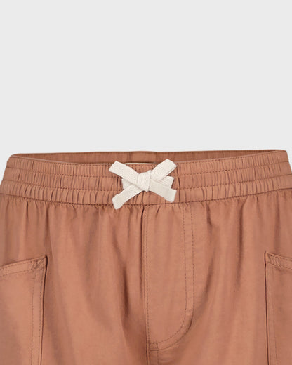 Brown shorts with a white drawstring on a light gray background