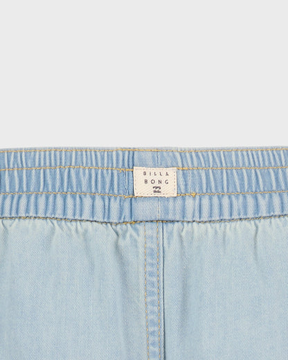 Close-up of light blue denim fabric with a Billabong label.