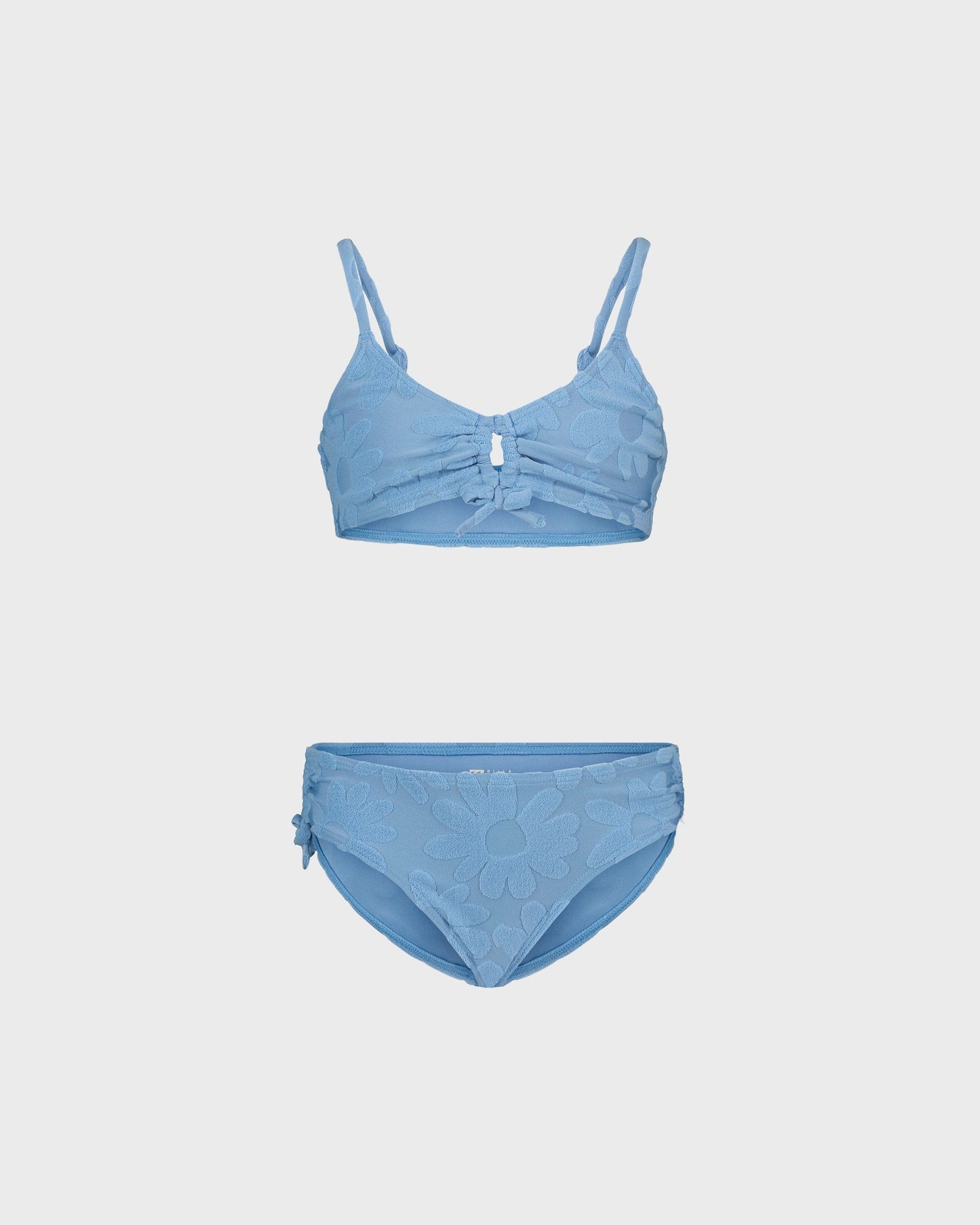 Blue bikini set on a light gray background