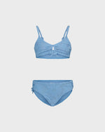 Blue bikini set on a light gray background